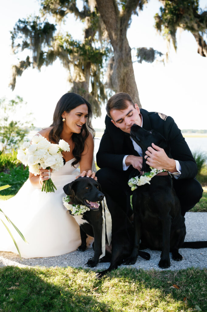 A bride and groom incorporate their two black labs in their wedding day on Crane Island in Amelia Island, FL captured by Tags Photography, an Amelia Island Wedding Photographer.