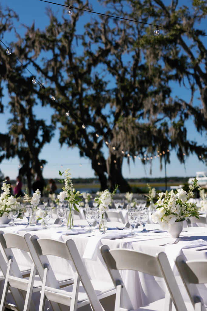 A bride and groom host their reception dinner at sunset on Crane Island in Amelia Island, FL captured by Tags Photography, an Amelia Island Wedding Photographer.