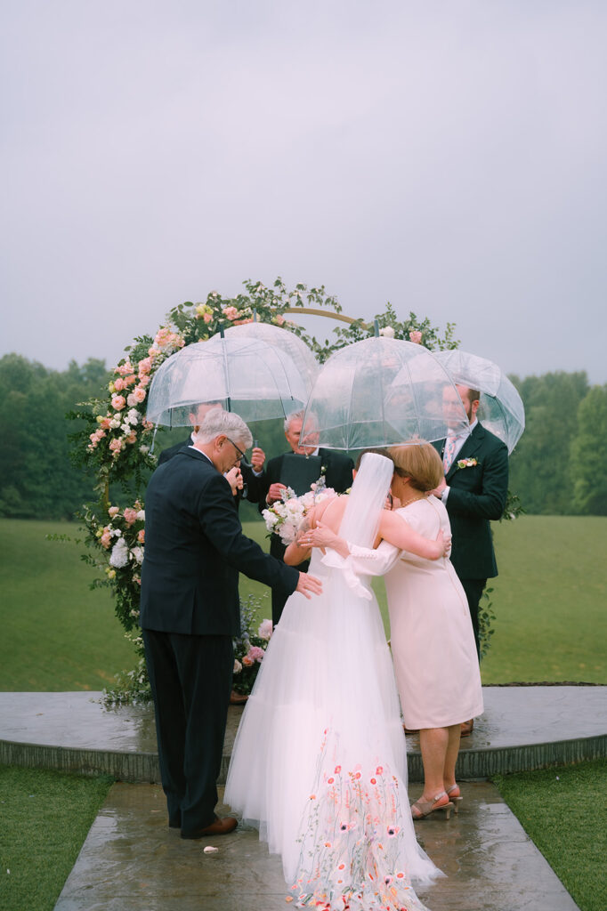 A rainy Spring wedding ceremony captured by Tags Photography at Meadows at Mossy Creek