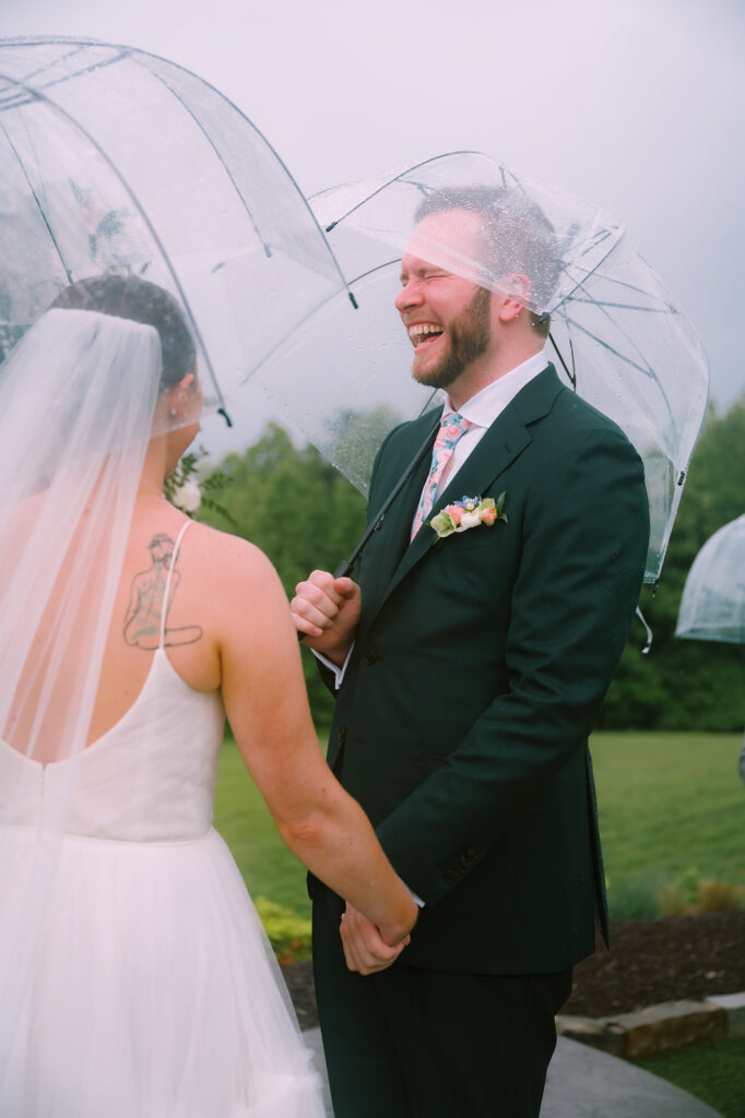 A rainy Spring wedding ceremony captured by Tags Photography at Meadows at Mossy Creek