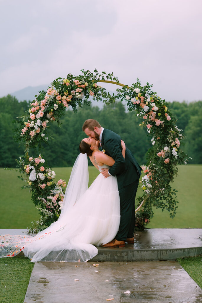 A rainy Spring wedding ceremony captured by Tags Photography at Meadows at Mossy Creek